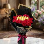 Red Rose Bouquet with Gold Chocolates in Black Gold-Edged Wrapping by Ideal Fresh Flower